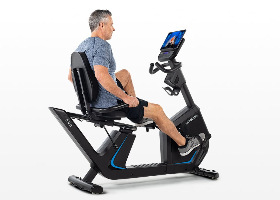 Rider pedaling the Horizon 5.0R Recumbent Bike