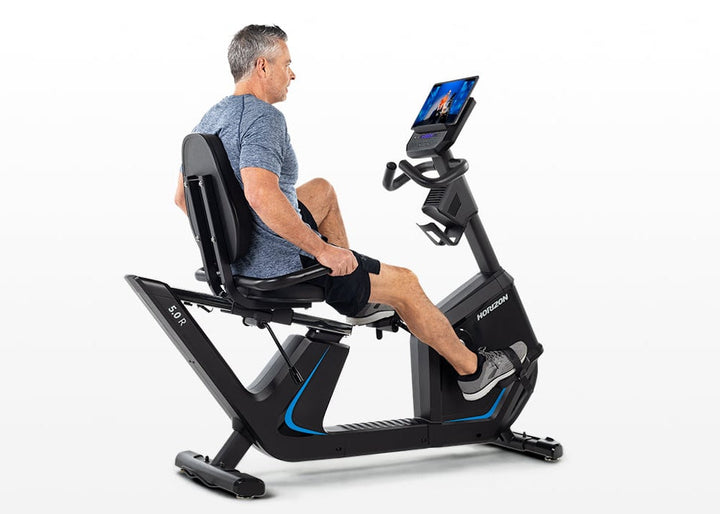 Rider pedaling the Horizon 5.0R Recumbent Bike
