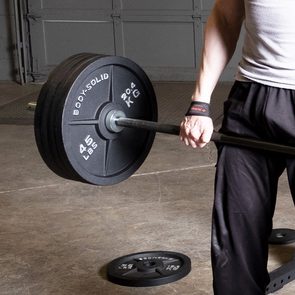 Cast iron Olympic weight plate on a barbell