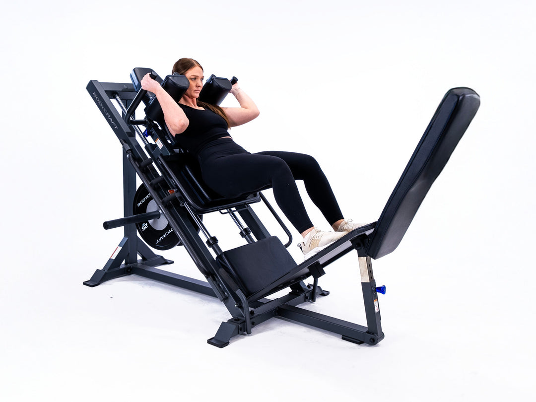Bodycraft F760 – model performing a hack squat under the shoulder pads
