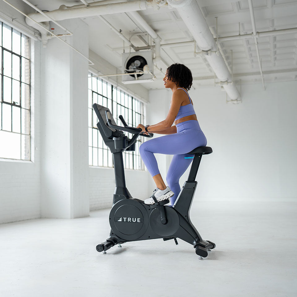 True Fitness Apex Upright Bike in use